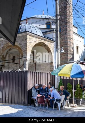 Playing cards by the mosque in the  bazaar at  Pec (Peja) in the Republic of Kosovo, in the central Balkans. Stock Photo