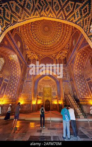 interior shot with golden decorated ceiling of Tilya-Kori-Madrasa or Tilla Kari Madrasah in famous Registan of Samarkand, Uzbekistan, Central Asia Stock Photo