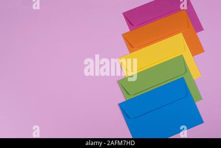 tidy coloured envelopes on a light pink background Stock Photo