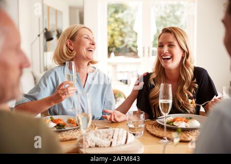 Family With Senior Parents And Adult Offspring Eating Brunch Around Table At Home Together Stock Photo