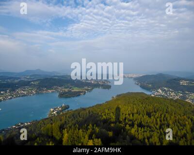 A view on the Wörthersee lake from the observation deck of Pyramidenkogel Tower. Lake is reflecting the last beams of sun for this day. Golden hour. T Stock Photo