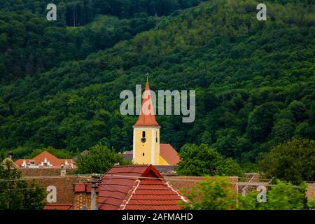 Sibiu, Romania, May 15, 2019: Roofs of old houses on a background of green mountains Stock Photo