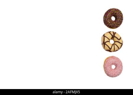various colored delicious donuts on white background, space for text Stock Photo
