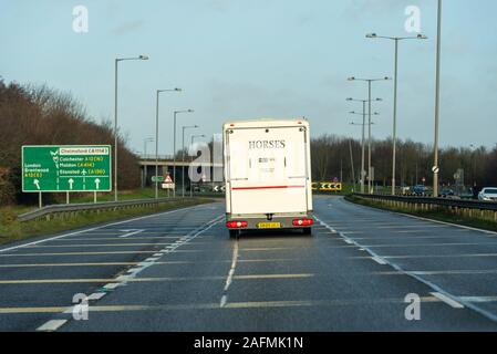 Destination sign with vehicles approaching A12 Chelmsford, Essex, UK driving on a stretch of A130 duel carriageway. Horse box Stock Photo