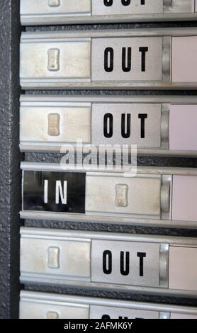 Office staff in/out indicator, office environment,slider Stock Photo