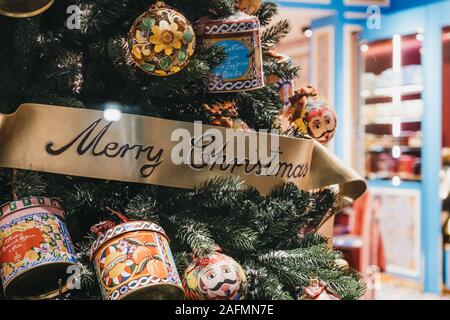 London, UK - November 17, 2019: Close up of Christmas tree with designer decorations in the window of a shop on Bond Street, one of the most famous st Stock Photo