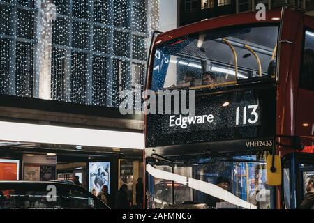 London, UK - November 17, 2019: Close up of a red double decker bus number 113 towards Edgware on Oxford Street, London, UK. Double decker bus is an i Stock Photo