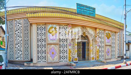 YANGON, MYANMAR - FEBRUARY 17, 2018: Panorama of the ornate Mon Rest House, decorated with molding, carved patterns, wall sculptures of Karaweik birds Stock Photo