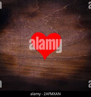 Red paper heart isolated on wooden background Stock Photo
