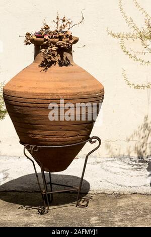 Old brown amphora in mediterranean style. Greece. Stock Photo