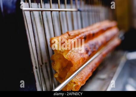 Traditional churro fried in oil for breakfast, made with wheat flour dough. Stock Photo