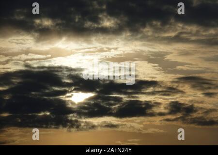 The sun shines through thunderclouds Stock Photo