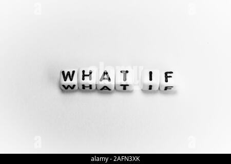 White cubes with question WHAT IF on white paper background and dark shadows Stock Photo