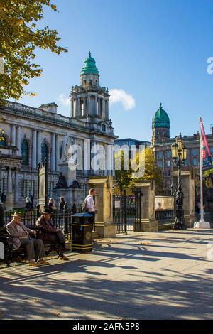 16 October 2019 A view of Belfast's City Hall westward along Donegall Square North Belfast Northern Ireland. Pensioners take a welcome seat in the bri