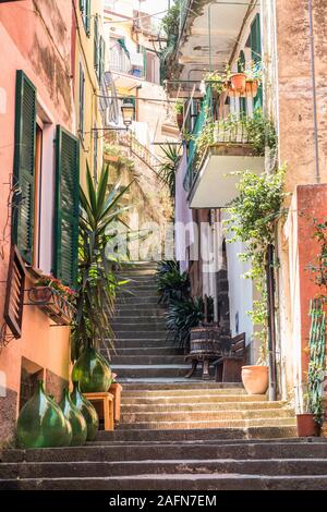 Characteristic and quaint street with steps leading to further houses taken in Monterosso, Italy in the Cinque Terre area. Stock Photo