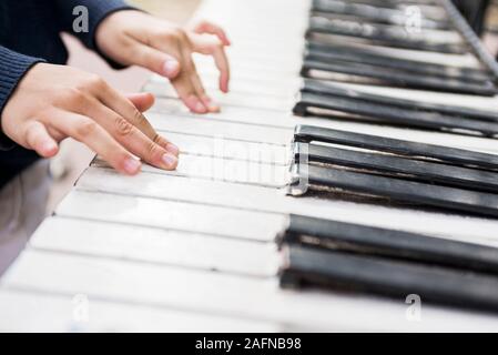 Children's hands on the keys of the piano. Piano lessons for kids. Stock Photo