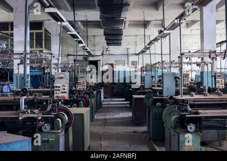YEREVAN, ARMENIA - Jul 07, 2019: Abandoned Textile Factory (Soviet) in Armenia. Closed after the collapse of the Soviet Union in 1991. Full of cotton, Stock Photo