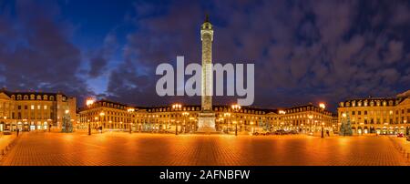 Panoramic view of Place Vendome with Christmas holiday decorations at dusk. In the center, the statue of Napoleon on top of the Vendome column.  Paris Stock Photo