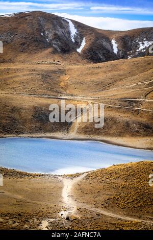 A couple of hikers are dwarfed by the landscape near the Lago de la Luna, Nevado de Toluca, Mexico. Stock Photo