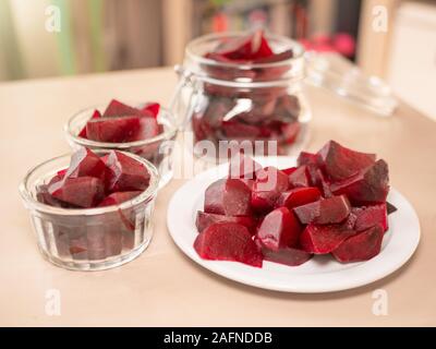 Cooked red slices beetroot in plate on wooden background. Stock Photo