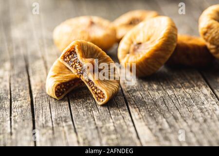 Sweet dried figs on old wooden table. Stock Photo