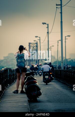 Tourist in Hanoi Vietnam Young Woman Standing on the Long Bien Bridge Stock Photo