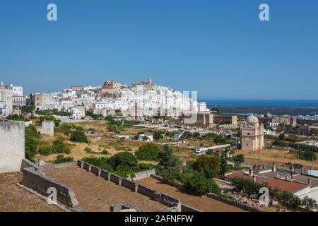 View towards the sea of Ostuni, an historic white hill town in Brindisi, Apulia, southern Italy, with gleaming whitewashed buildings in summer Stock Photo