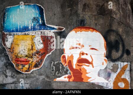 Cut-to-shape street art poster of Charlie Chaplin eating Nike sneaker.  Trastevere district of Rome, Italy Stock Photo - Alamy