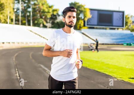 A young man run a hundred meters on the treadmill. Stock Photo