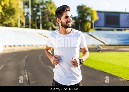 A young man run a hundred meters on the treadmill. Stock Photo