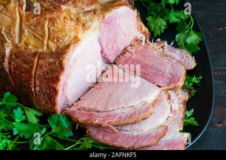 Sliced Brown Sugar and Apple Cider Glazed Ham on a Platter Stock Photo