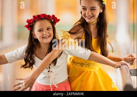 Two girls joking around wearing ballet costumes. Stock Photo