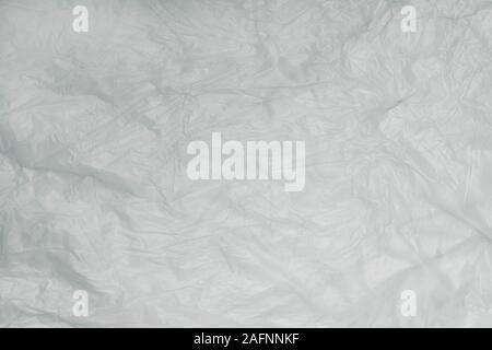 Abstract texture of light crumpled polyethylene, plastic for recycling, concept of ecology, environmental pollution