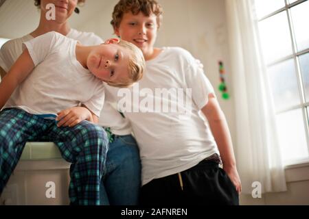 Silly family portrait of a mother and her two sons. Stock Photo