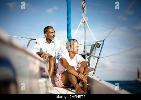 Mature couple relaxing together on boat deck in the sunshine. Stock Photo