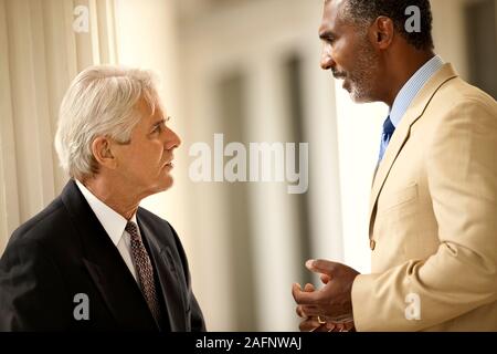 Two angry-looking business colleagues arguing. Stock Photo