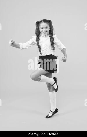 Keep going. Active kid. Girl on way knowledge. Knowledge day. Back to school. Kid cheerful schoolgirl running. Pupil want study. Active child in motion. Freedom concept. Knowledge determined success. Stock Photo