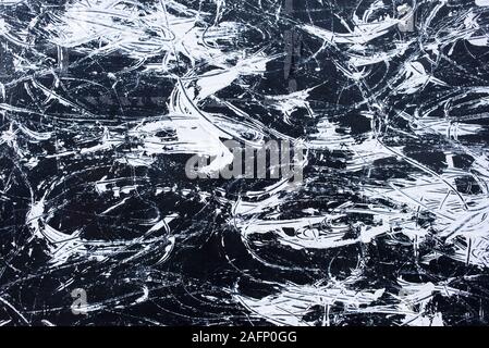 White hand painting messy brush finish on black wall Stock Photo