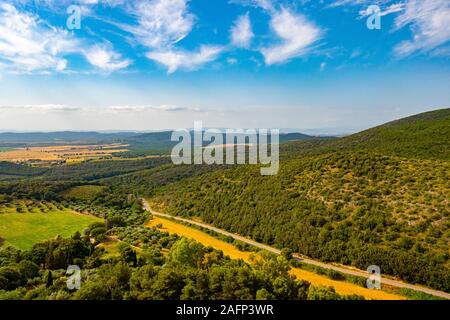 landscape from the hill of Capalbio in Tuscany with blue sky and woods Stock Photo
