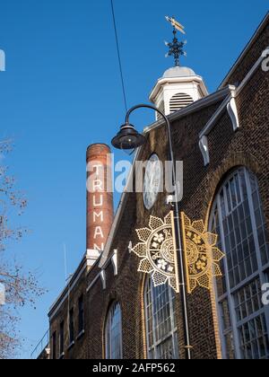 Old Truman Brewery building on Brick Lane, East London UK, with iconic chimney, now used as a retail, leisure and business event space. Stock Photo