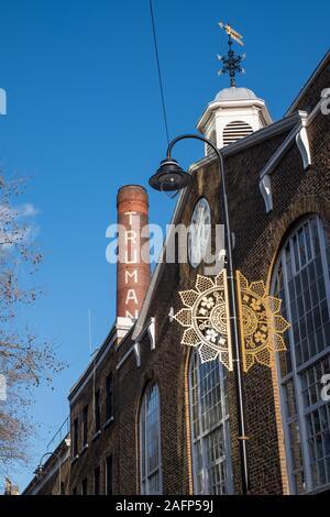 Old Truman Brewery building on Brick Lane, East London UK, with iconic chimney, now used as a retail, leisure and business event space. Stock Photo