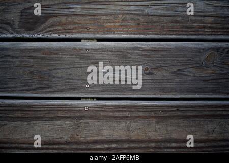 these are some horizontal wooden planks of an old weathered deck after a rain fall Stock Photo