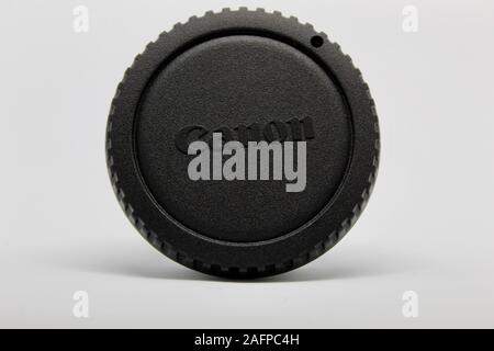 Black Canon Camera Lens Cap on White Background Stock Photo