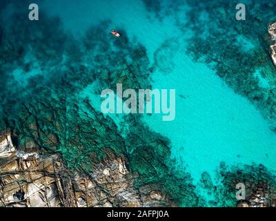 aerial drone view of kayak in tropical bright blue ocean reef Mexico Stock Photo