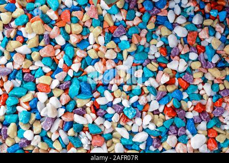 Vibrant colorful marble fine gravel. Simple stone background with bright multicolor pebbles. Stone texture. Top view of ground decor for garden with c Stock Photo
