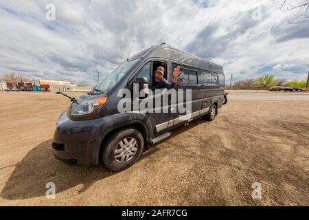 MAY 21 2019, USA -  Bill Terry behind wheel of RV waves on Lewis and Clark Journey along Route 2, Montana Stock Photo