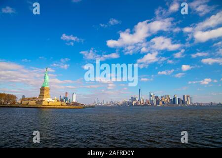 Statue of Liberty and New York Skyline isolated on the blue sky with white clouds. October 11,2018