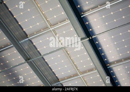 Underside design of a solar panels installed as solar canopy on top of parking garage. Solar panels convert the sun's rays into electricity and provid Stock Photo