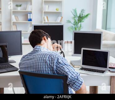 The businessman sitting in front of many screens Stock Photo