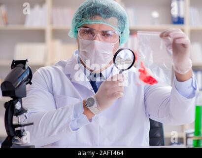 The forensics investigator working in lab on crime evidence Stock Photo